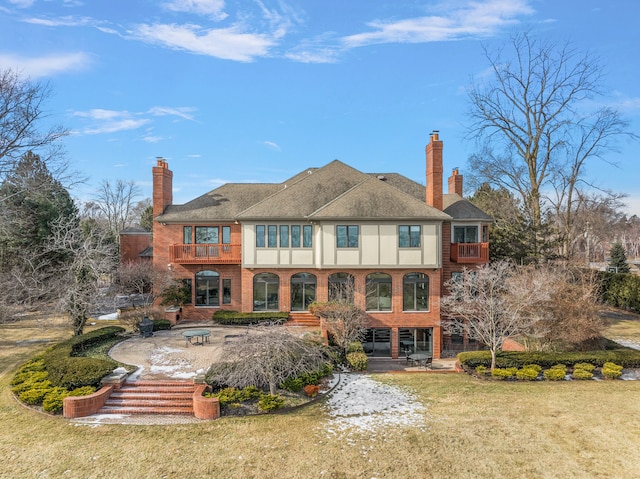 rear view of property with an outdoor fire pit, a patio, and a yard