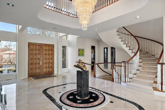 entrance foyer featuring a chandelier and a towering ceiling