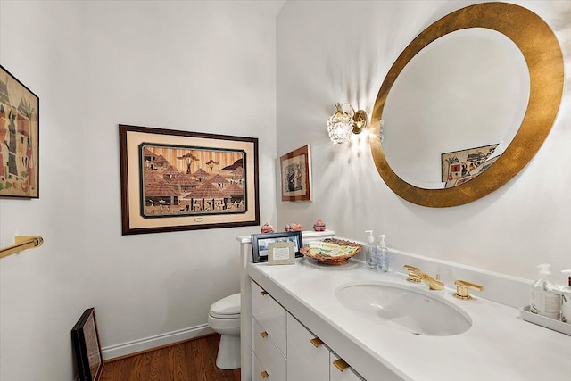 bathroom featuring vanity, toilet, and hardwood / wood-style floors