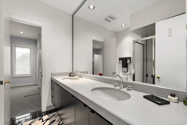 bathroom with an enclosed shower and vanity