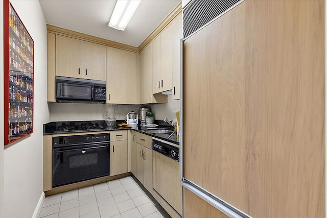 kitchen featuring light tile patterned flooring, sink, black appliances, and light brown cabinetry