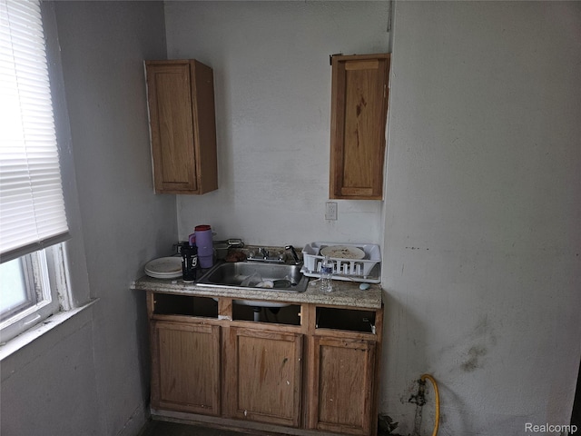 65 Portage St, Highland Park, MI 48203 - kitchen featuring a sink, brown cabinets, and light countertops