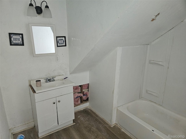 65 Portage St, Highland Park, MI 48203 - bathroom featuring wood finished floors, vanity, a bathtub, and baseboards