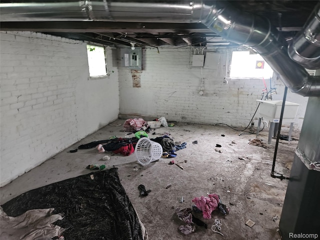 65 Portage St, Highland Park, MI 48203 - basement with plenty of natural light, electric panel, a sink, and brick wall