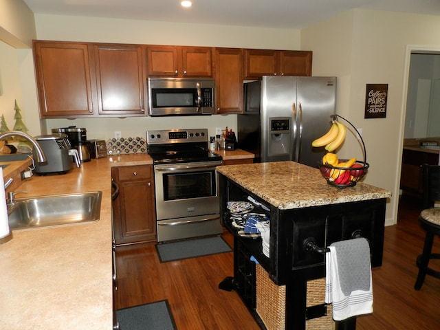 kitchen featuring dark wood-type flooring, appliances with stainless steel finishes, and sink