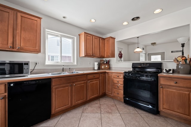 kitchen with sink, black appliances, light tile patterned flooring, decorative light fixtures, and kitchen peninsula