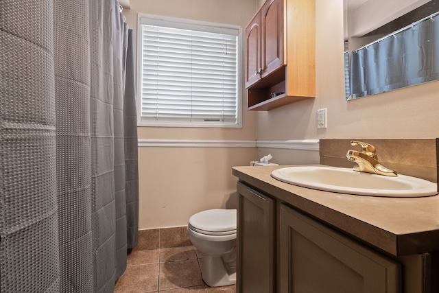 bathroom with tile patterned flooring, vanity, curtained shower, and toilet