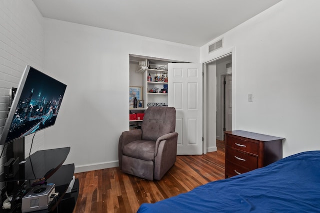 bedroom featuring dark hardwood / wood-style flooring and a closet