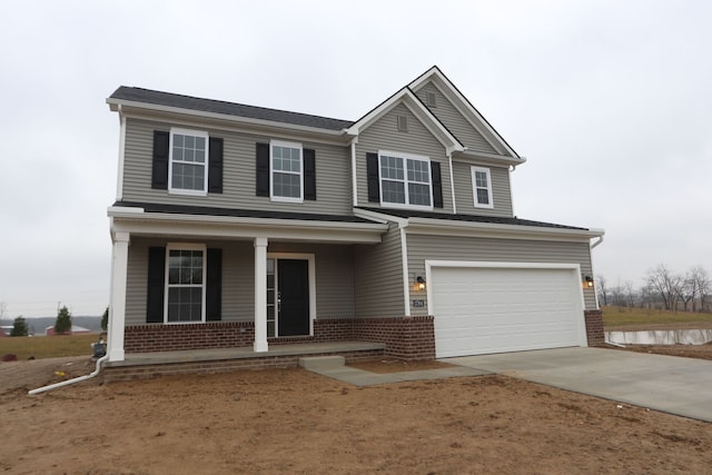 view of front of property with a garage and covered porch