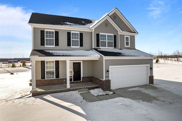 view of front facade with a porch, brick siding, driveway, and a garage