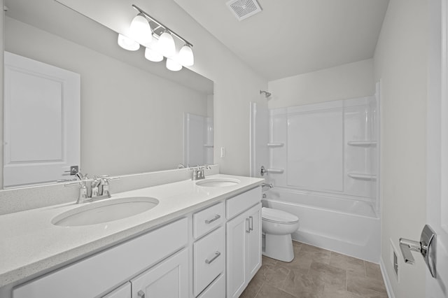 bathroom featuring toilet, double vanity, a sink, and visible vents