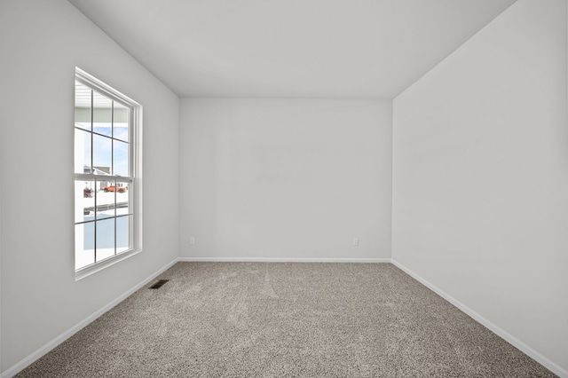 carpeted empty room with baseboards and visible vents