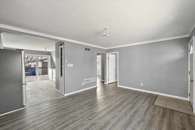 empty room with crown molding, ceiling fan, and light hardwood / wood-style flooring