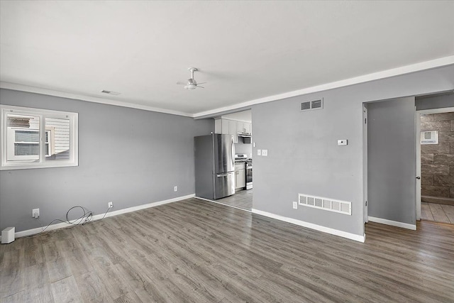 empty room featuring crown molding, ceiling fan, and hardwood / wood-style floors