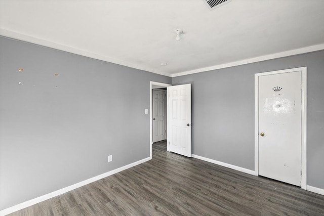 spare room with dark hardwood / wood-style flooring