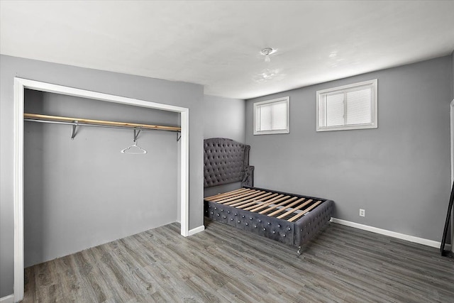 bedroom with hardwood / wood-style flooring and a closet