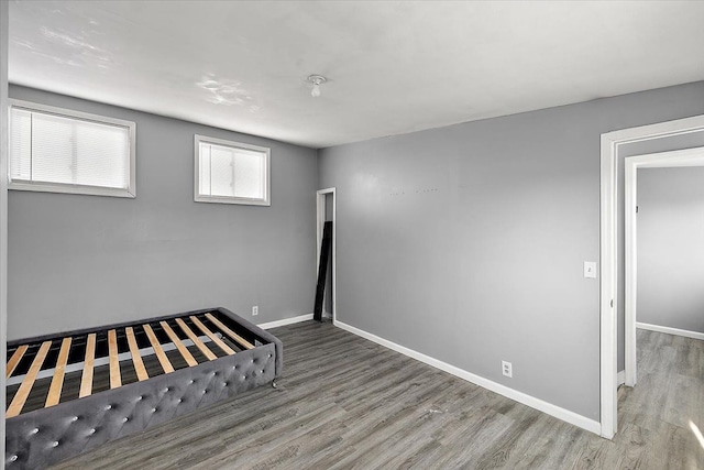 unfurnished bedroom with hardwood / wood-style flooring