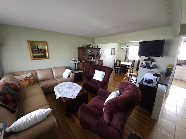 living room with hardwood / wood-style floors and an inviting chandelier