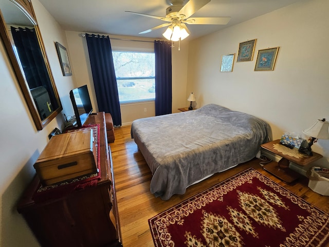 bedroom with hardwood / wood-style flooring and ceiling fan