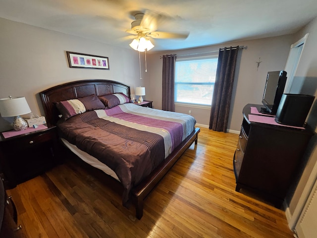 bedroom with ceiling fan and light hardwood / wood-style floors