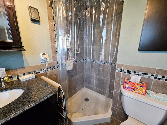 bathroom with toilet, curtained shower, and tile walls