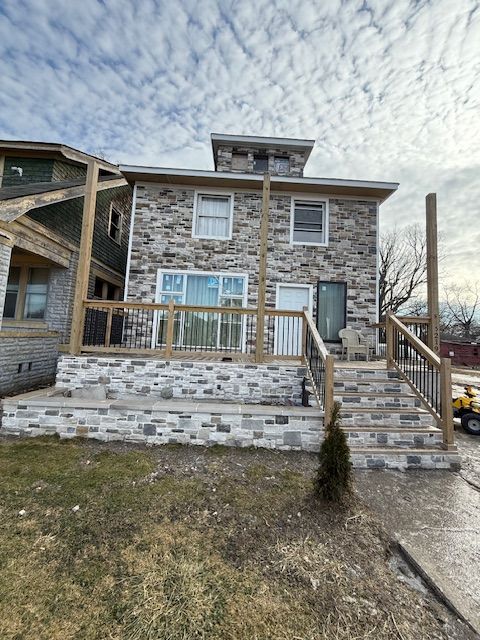 rear view of property with a wooden deck