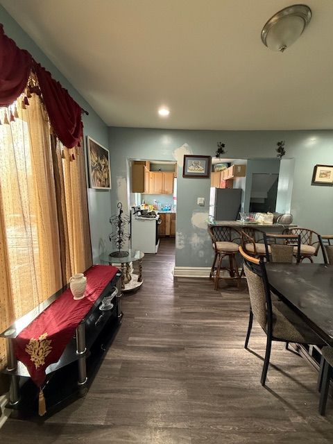 dining space with dark hardwood / wood-style floors