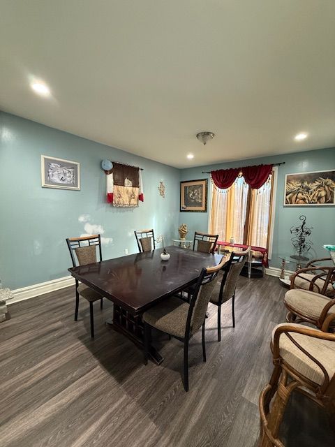 dining area with dark wood-type flooring