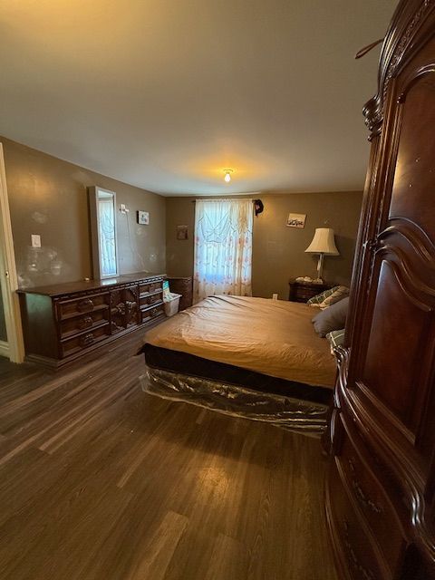 bedroom featuring dark hardwood / wood-style flooring