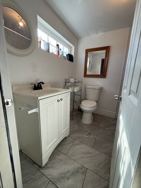 bathroom featuring vanity and toilet