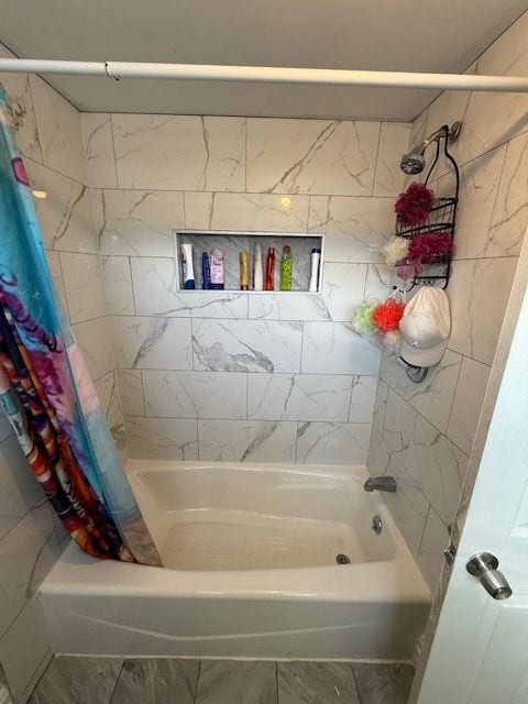 bathroom with shower / bath combo with shower curtain