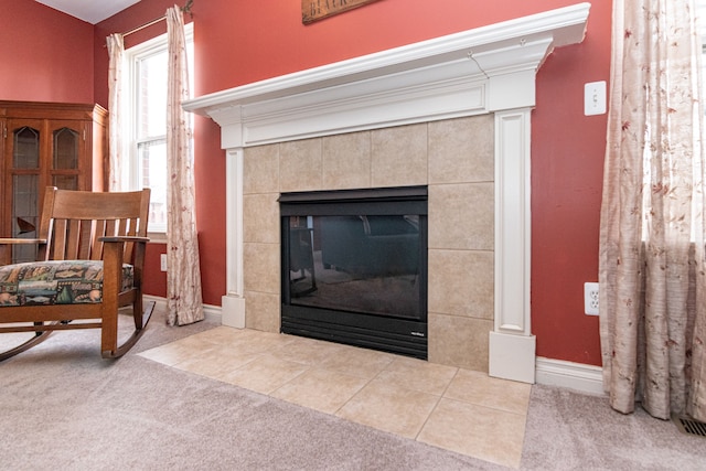 room details with a tile fireplace and carpet floors