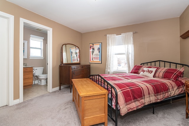 carpeted bedroom featuring ensuite bathroom