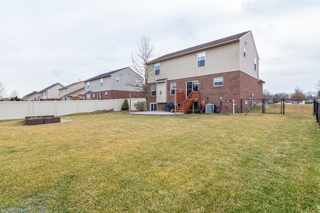 back of house with a yard, a patio area, and central AC unit