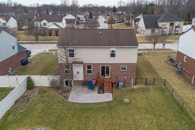 rear view of property featuring central AC, a patio, and a yard