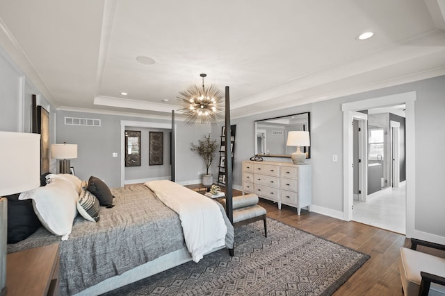 bedroom featuring a raised ceiling, crown molding, a notable chandelier, and dark hardwood / wood-style flooring