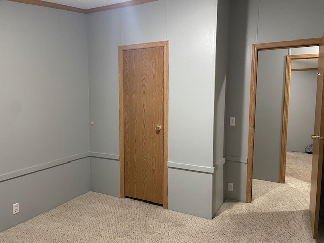 unfurnished bedroom featuring light colored carpet