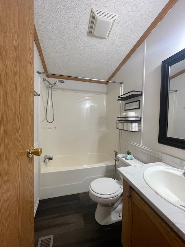 full bathroom with toilet, a textured ceiling, ornamental molding, vanity, and hardwood / wood-style floors