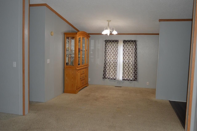 dining area with crown molding, light colored carpet, and an inviting chandelier