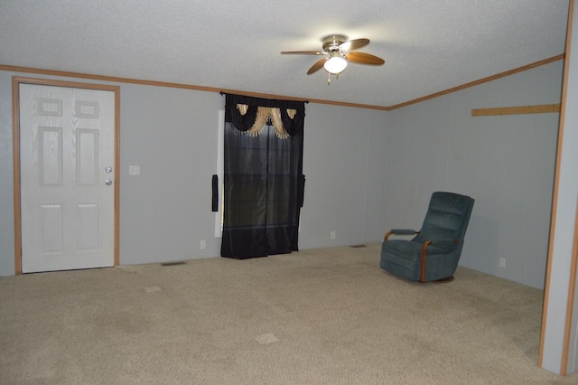 unfurnished room with light carpet, ceiling fan, crown molding, and a textured ceiling