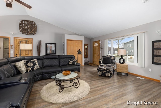 living room with hardwood / wood-style flooring and vaulted ceiling