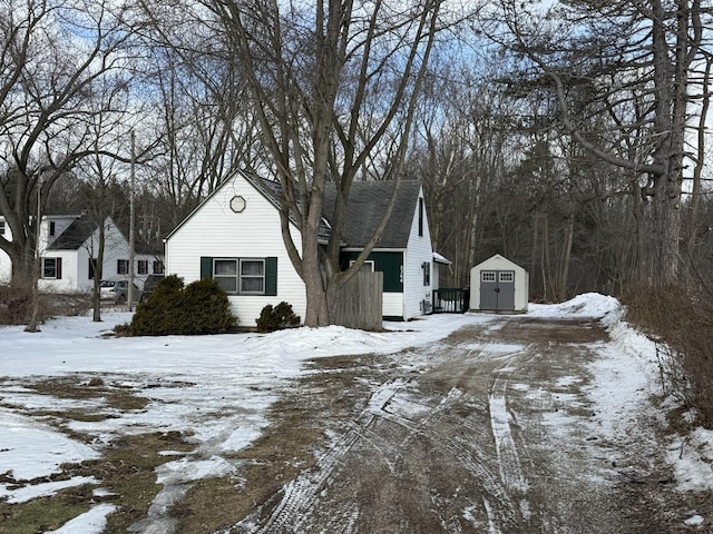 view of snow covered exterior featuring a storage unit