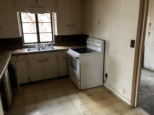 kitchen with light countertops, a sink, white electric stove, and light floors