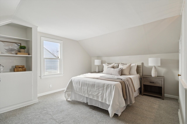 bedroom featuring lofted ceiling and light carpet