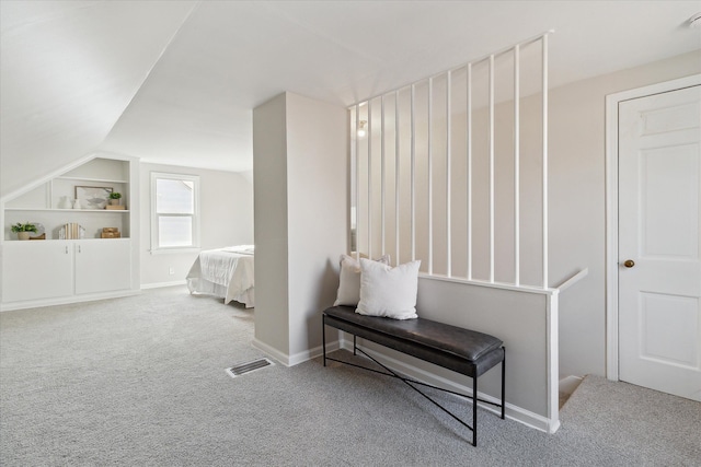 carpeted bedroom with lofted ceiling