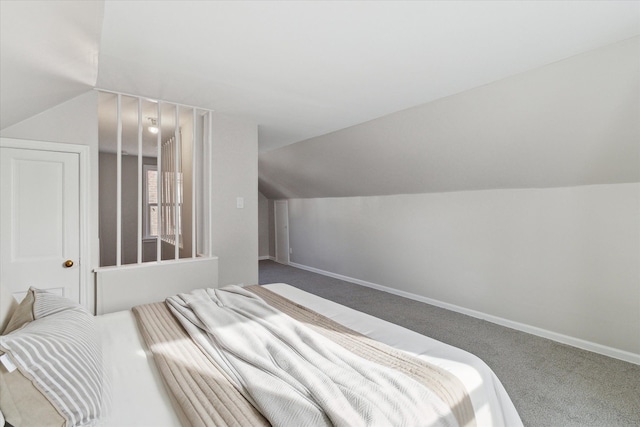 carpeted bedroom with lofted ceiling