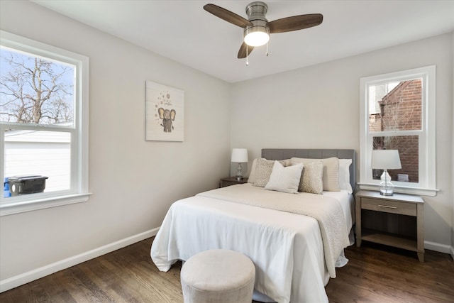 bedroom with multiple windows, ceiling fan, and dark hardwood / wood-style flooring