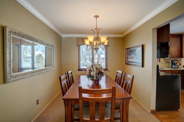 carpeted dining area featuring crown molding, a healthy amount of sunlight, and a chandelier