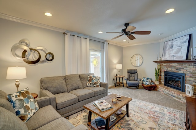 carpeted living room featuring crown molding, a brick fireplace, and ceiling fan