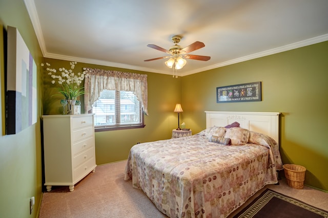 carpeted bedroom featuring ceiling fan and ornamental molding